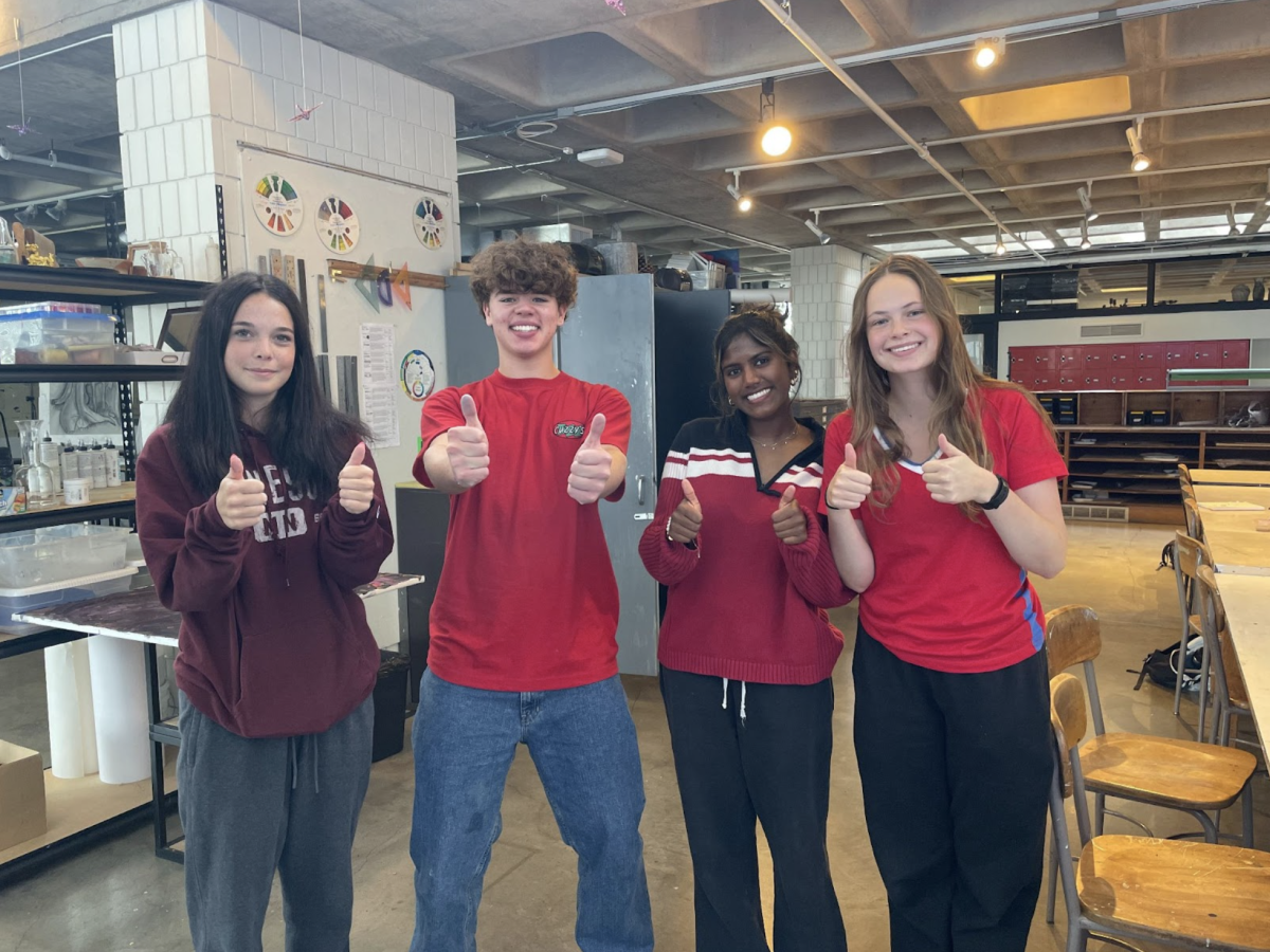 THUMBS UP. Juniors Nellie Larson, Fletcher Coblentz, Sona Jain, and Lily Currie (left to right) were a scarlet snapshot for the Class of 2026, showing up in varying hues of red. In short sleeves, Currie and Coblentz opt for a more intense shade of the primary color, while Larson and Jain stick to a darker tone in long sleeves.  